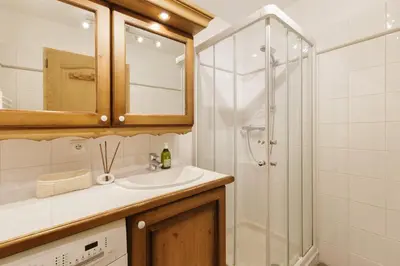 a bathroom with a sink and a shower at Le Hameau des Glaciers - Ski & Vue Incroyable in Les Houches