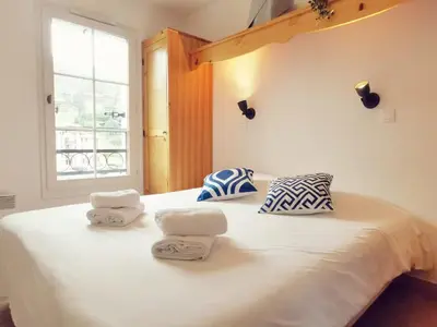 a bedroom with a white bed with towels on it at Grand Panorama in Saint-Gervais-les-Bains