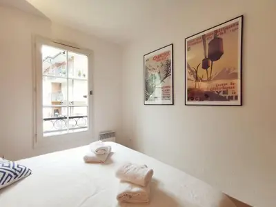a bedroom with two towels on a bed with a window at Grand Panorama in Saint-Gervais-les-Bains