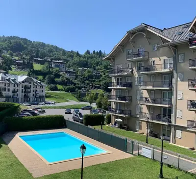 a view of a apartment building and a swimming pool at Grand Panorama in Saint-Gervais-les-Bains