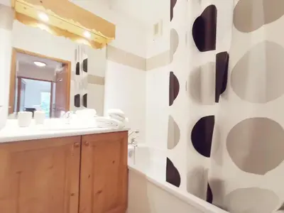 a bathroom with a sink and a mirror at Grand Panorama in Saint-Gervais-les-Bains