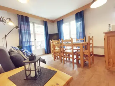 a living room with a dining room table and chairs at Grand Panorama in Saint-Gervais-les-Bains