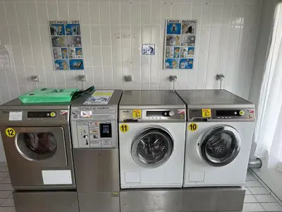 three washing machines are in a laundry room at Grand Panorama in Saint-Gervais-les-Bains