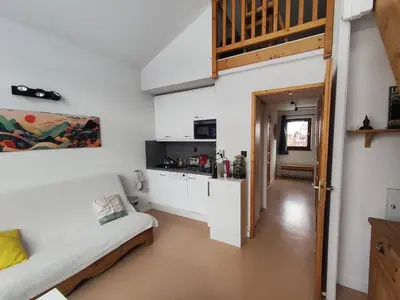 a living room with a couch and a kitchen at Les Eterlous N44 2P6 in Morillon