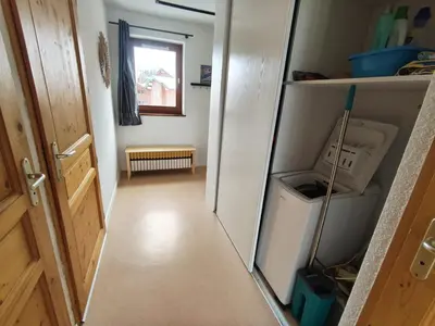 a hallway with a door open to a kitchen with a refrigerator at Les Eterlous N44 2P6 in Morillon