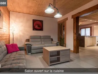 a living room with a couch and a table at L'Arbaz in Samoëns