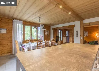 a large room with a table and a dining room at L'Arbaz in Samoëns