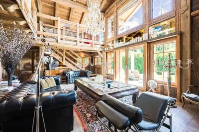 a living room with a couch and a table at Luxury Stay Comfortable Chalet with Jacuzzi in Megève