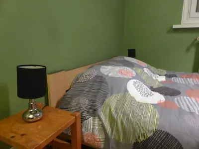 a bedroom with a bed and a table with a lamp at Appartement central avec grande terrasse Sud pour 4 personnes - FR-1-836-61 in Arâches-la-Frasse