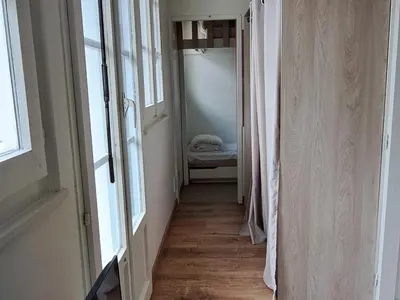 a hallway with a room with a bed and windows at Appartement central avec grande terrasse Sud pour 4 personnes - FR-1-836-61 in Arâches-la-Frasse