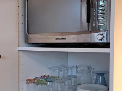 a microwave oven sitting on top of a shelf at Appartement central avec grande terrasse Sud pour 4 personnes - FR-1-836-61 in Arâches-la-Frasse
