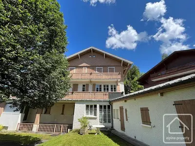 a large house with a gambrel roof at Appartement central avec grande terrasse Sud pour 4 personnes - FR-1-836-61 in Arâches-la-Frasse