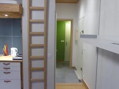 a kitchen with a ladder leading into a room at Appartement central avec grande terrasse Sud pour 4 personnes - FR-1-836-61 in Arâches-la-Frasse