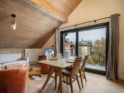 a dining room with a table and a large window at Appartement moderne Saint-Gervais 6 pers, proche remontées mécaniques - FR-1-663-58 in Saint-Gervais-les-Bains