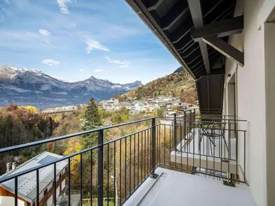 a kitchen with white cabinets and a table and a window at Appartement moderne Saint-Gervais 6 pers, proche remontées mécaniques - FR-1-663-58 in Saint-Gervais-les-Bains