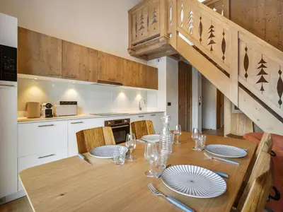 a kitchen with a wooden table with chairs and a staircase at Appartement moderne Saint-Gervais 6 pers, proche remontées mécaniques - FR-1-663-58 in Saint-Gervais-les-Bains