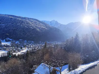 a town in the mountains with snow on the ground at Le Montagnard in Saint-Gervais-les-Bains