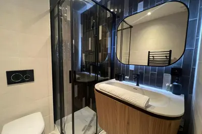 a bathroom with a sink and a mirror at Appartement Reflet des Cimes - Welkeys in Megève
