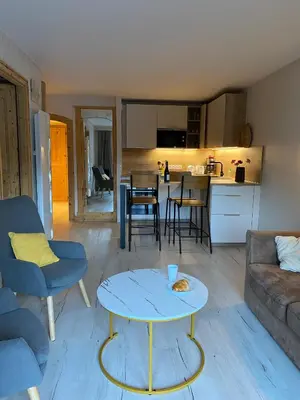 a living room with a couch and a table at MontBlanc11 in Chamonix-Mont-Blanc