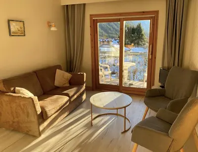 a living room with a couch and two chairs and a table at MontBlanc11 in Chamonix-Mont-Blanc