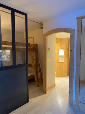 a room with a bunk bed and a doorway at MontBlanc11 in Chamonix-Mont-Blanc