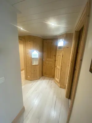 an empty room with wooden walls and wooden floors at MontBlanc11 in Chamonix-Mont-Blanc