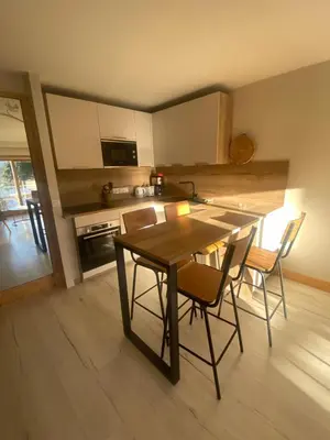 a kitchen with a wooden table and chairs in a room at MontBlanc11 in Chamonix-Mont-Blanc