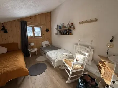 a bedroom with two beds and a crib in it at Studio mezzanine à 300m des pistes, balcon sud, jusqu'à 4 personnes - FR-1-572-342 in Arâches-la-Frasse