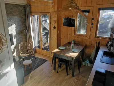 a dining room with a table and chairs in a cabin at Studio mezzanine à 300m des pistes, balcon sud, jusqu'à 4 personnes - FR-1-572-342 in Arâches-la-Frasse