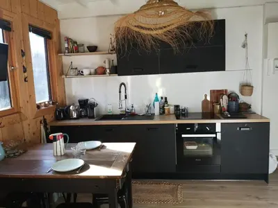a kitchen with a table and a sink and a stove at Studio mezzanine à 300m des pistes, balcon sud, jusqu'à 4 personnes - FR-1-572-342 in Arâches-la-Frasse