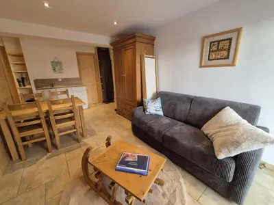 a living room with a couch and a table at Appartement rénové 1 chambre avec balcon, parking et wifi centre station - FR-1-836-62 in Arâches-la-Frasse
