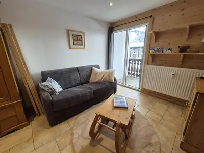 a living room with a couch and a coffee table at Appartement rénové 1 chambre avec balcon, parking et wifi centre station - FR-1-836-62 in Arâches-la-Frasse