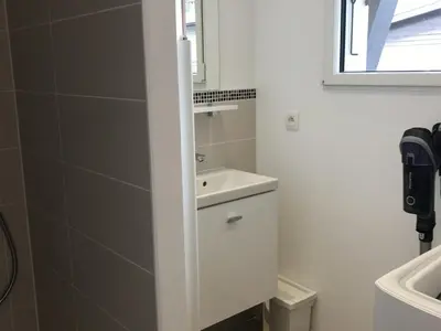 a white bathroom with a sink and a mirror at Appartement rénové 1 chambre avec balcon, parking et wifi centre station - FR-1-836-62 in Arâches-la-Frasse