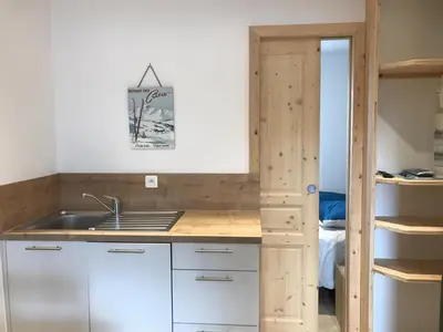 a kitchen with a sink and a bunk bed at Appartement rénové 1 chambre avec balcon, parking et wifi centre station - FR-1-836-62 in Arâches-la-Frasse
