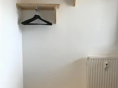 a black hanger on a wall next to a radiator at Appartement rénové 1 chambre avec balcon, parking et wifi centre station - FR-1-836-62 in Arâches-la-Frasse