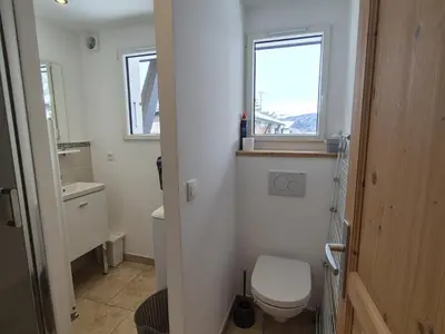 a small bathroom with a toilet and a window at Appartement rénové 1 chambre avec balcon, parking et wifi centre station - FR-1-836-62 in Arâches-la-Frasse