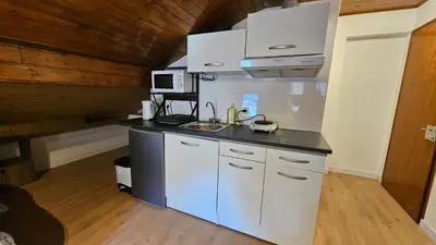 a kitchen with a sink and a counter top at Mini cozy au MontBlanc in Sallanches