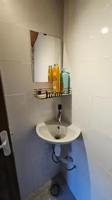 a bathroom with a sink and a mirror at Mini cozy au MontBlanc in Sallanches