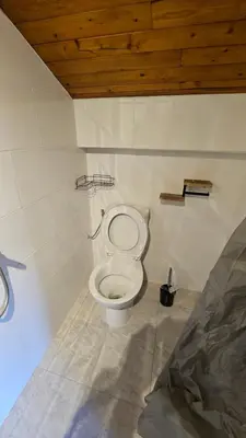 a bathroom with a white toilet in a room at Mini cozy au MontBlanc in Sallanches