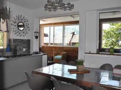 a kitchen and dining room with a table and chairs at Appartement rénové 2 chambres, centre station, 300m des pistes, 6 pers, WiFi - FR-1-836-63 in Arâches-la-Frasse