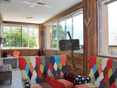 a living room with two chairs and windows at Appartement rénové 2 chambres, centre station, 300m des pistes, 6 pers, WiFi - FR-1-836-63 in Arâches-la-Frasse
