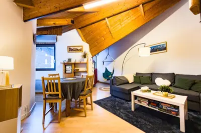 a living room with a couch and a table at Bright studio with a view of Mont Blanc in Chamonix-Mont-Blanc