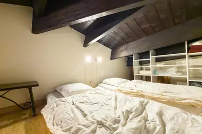 a bedroom with a large white bed in a room at Bright studio with a view of Mont Blanc in Chamonix-Mont-Blanc