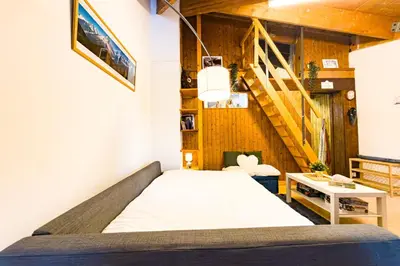 a bed in a room with a staircase at Bright studio with a view of Mont Blanc in Chamonix-Mont-Blanc