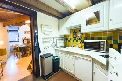 a kitchen with white cabinets and a microwave at Bright studio with a view of Mont Blanc in Chamonix-Mont-Blanc