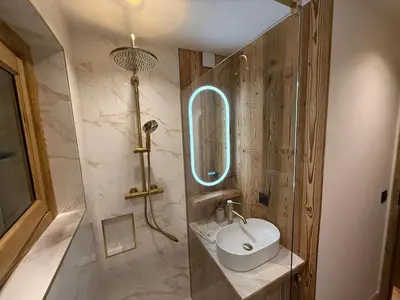 a bathroom with a sink and a mirror at Charmant appartement en plein centre in Megève