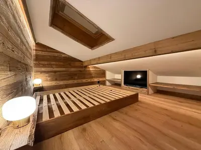 a large room with a bed and a tv at Charmant appartement en plein centre in Megève
