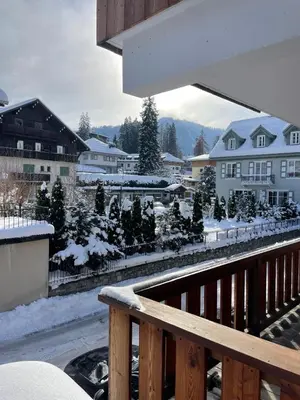 a balcony with a view of a town in the snow at Charmant appartement en plein centre in Megève