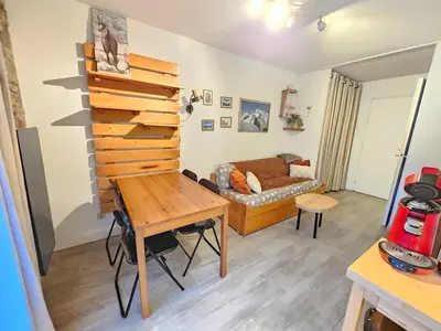 a living room with a table and a couch at appartement proche ski et randonnées, vue montagne in Saint-Gervais-les-Bains