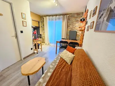 a room with a bed and a table and a desk at appartement proche ski et randonnées, vue montagne in Saint-Gervais-les-Bains